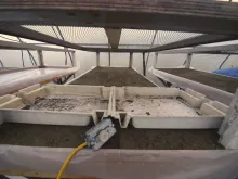 The "bathtubs" are filled with sand and saturated with water, and wired to a standard baseboard heater thermostat.